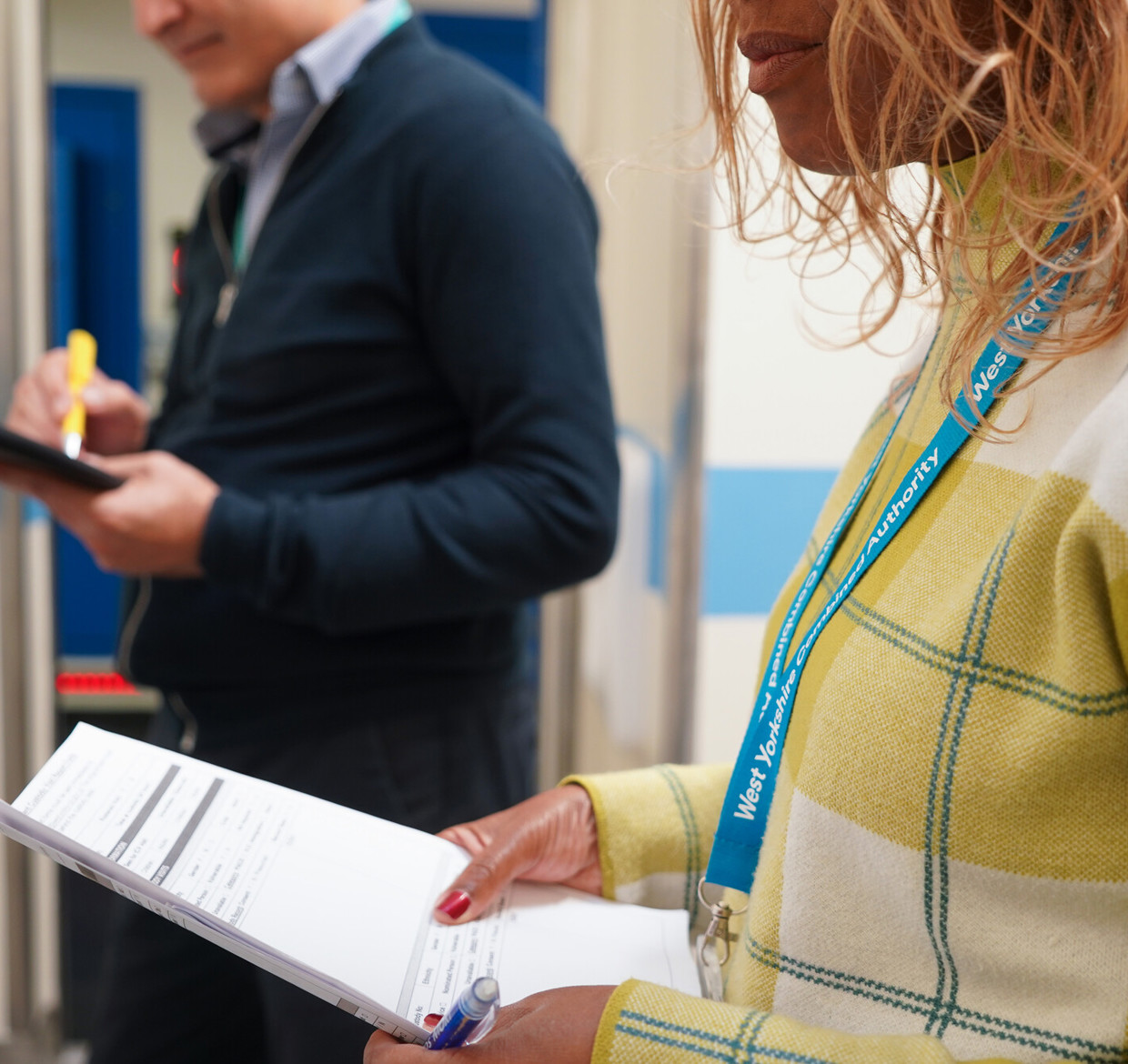 Two Independent Custody Visitors filling out paperwork in the custody suite