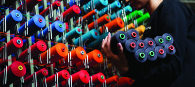 Person working with spools of thread