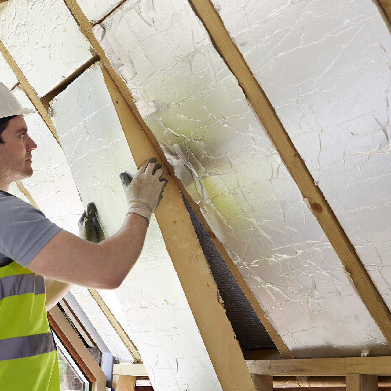 Man installing roof insulation
