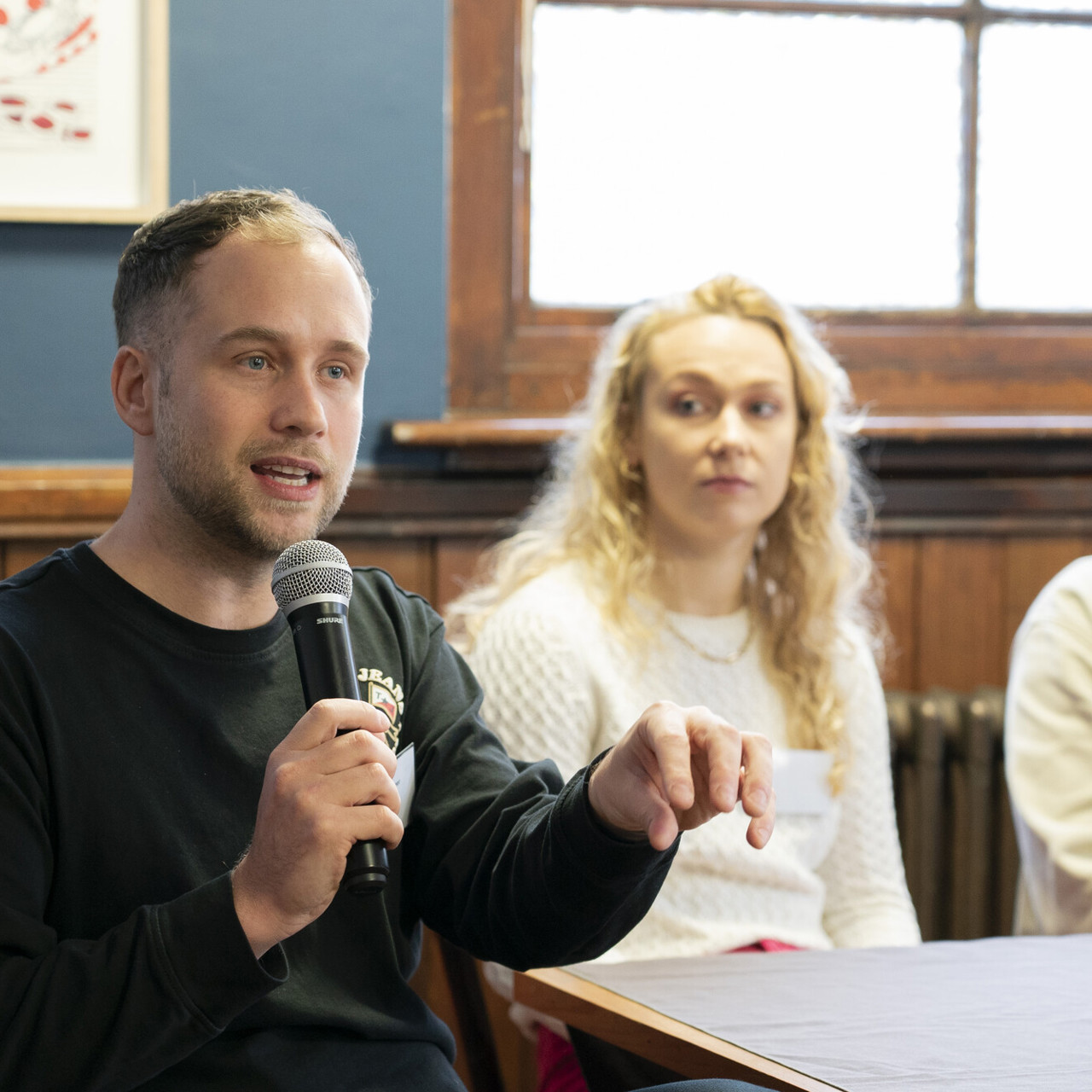 People at Skills For Growth Event 2023, with delegate speaking into microphone