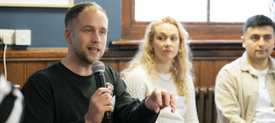 People at Skills For Growth Event 2023, with delegate speaking into microphone
