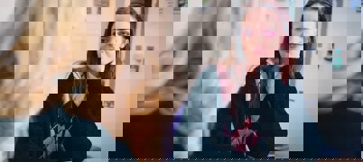 A young woman speaking to an Employment support adviser for career advice