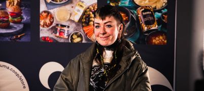 A woman in a leather jacket, smiling