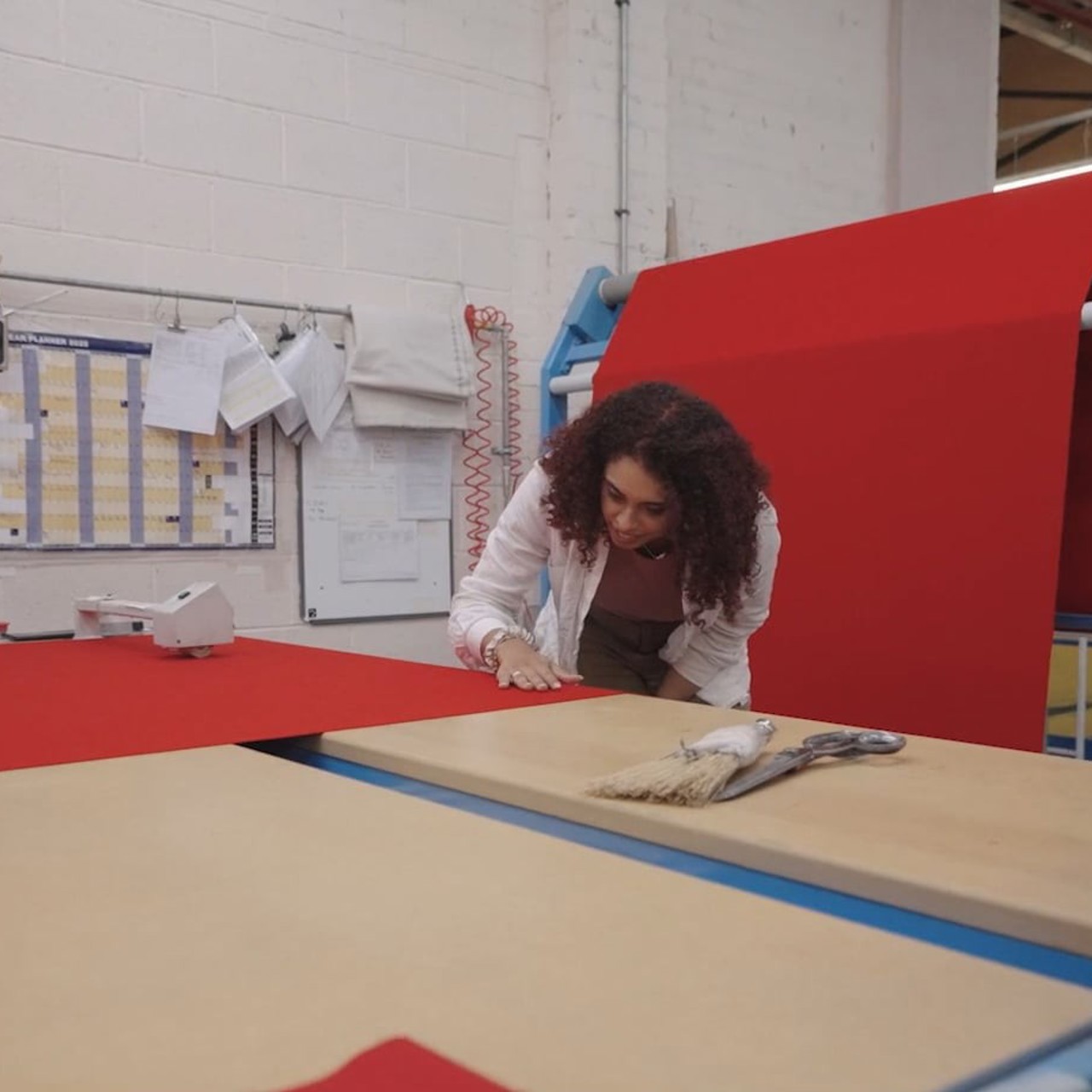 Woman inspecting fabric in a textile factory