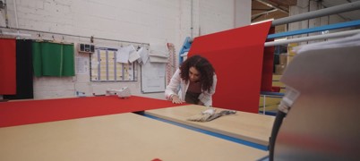 Woman inspecting fabric in a textile factory