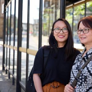 Two Women At Bus Stop