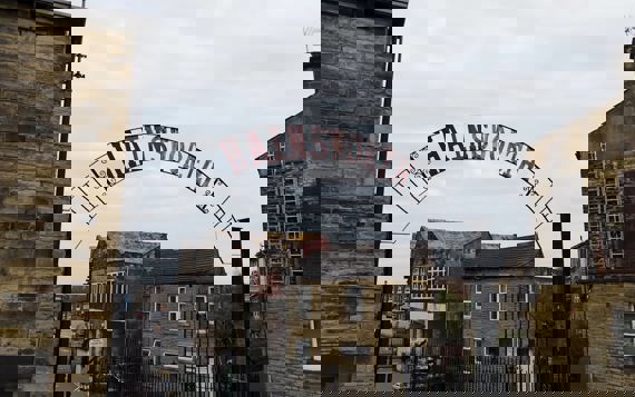 A large iron gate with the word "Hainsworth"