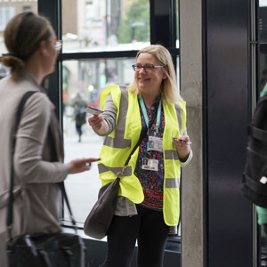 Combined Authority Colleague Handing Out Flyers At Big Bus Chat In Leeds Station