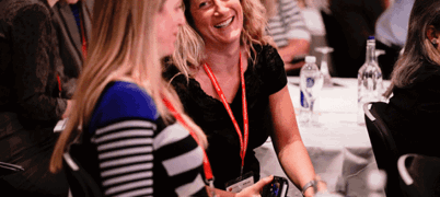 Two people talking at an event