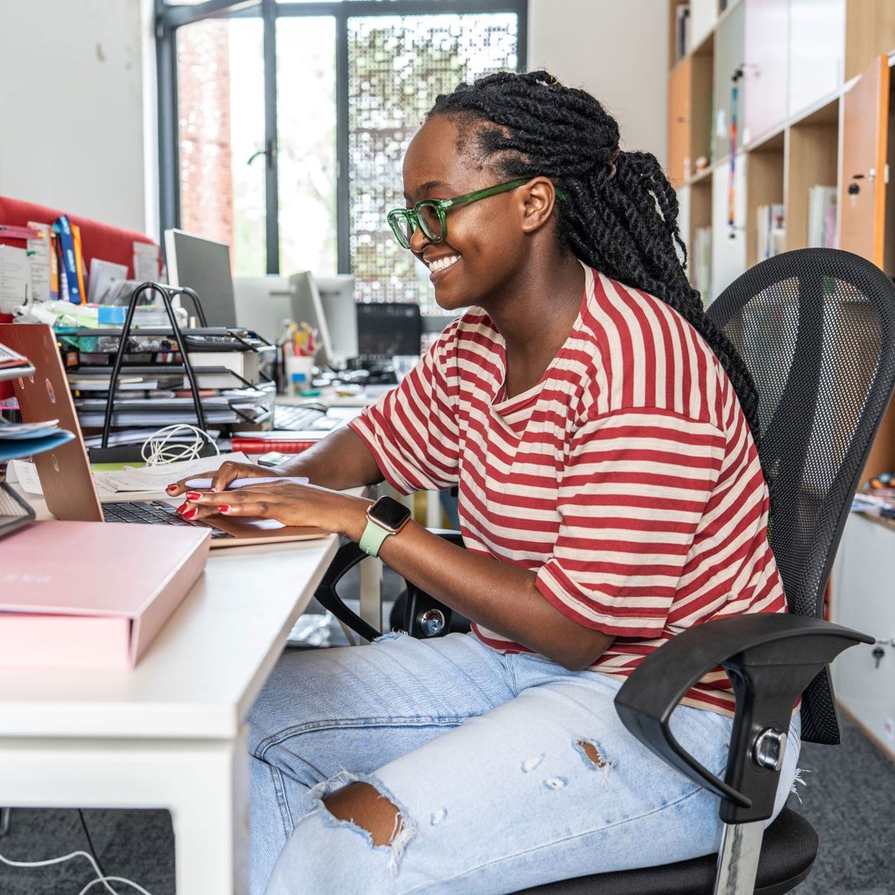 A Black Female Office Worker At Her Laptop