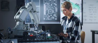 Woman concentrates on laptop and equipment