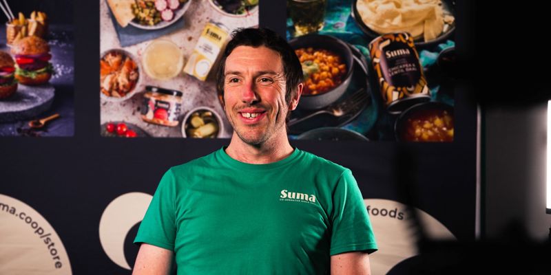 A man in a green shirt, smiling