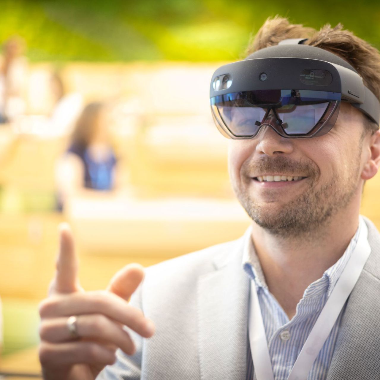 Man with beard smile and pints wearing VR goggles