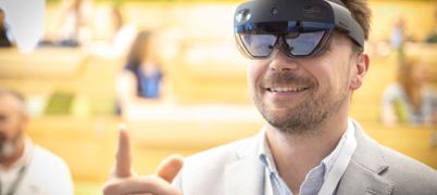 Man with beard smile and pints wearing VR goggles