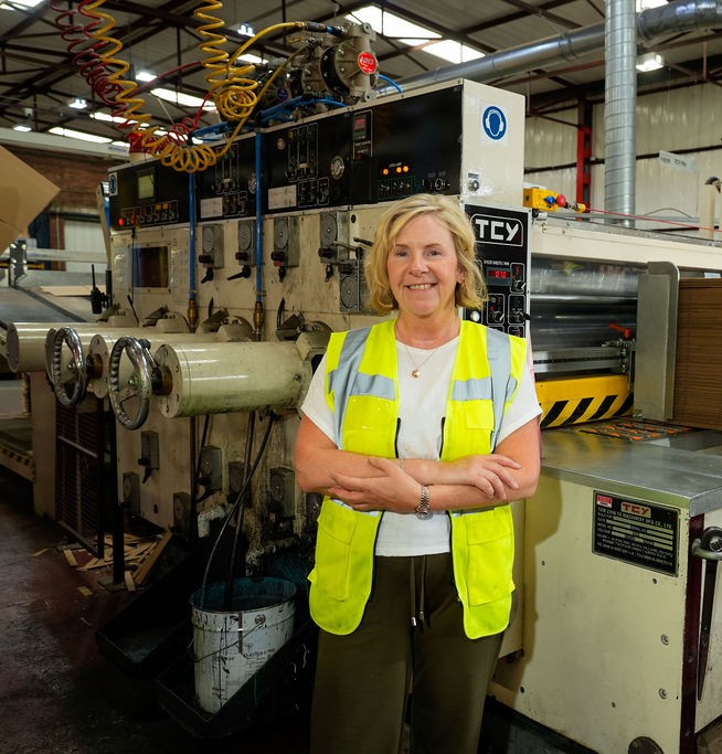 Woman in standing in manufacturing factory