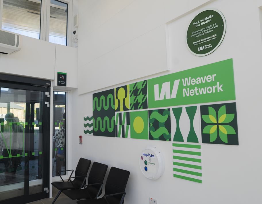 Heckmondwike Weaver Network green plaque and artwork inside the bus station