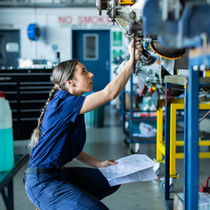 Female aircraft engineer working on machinery