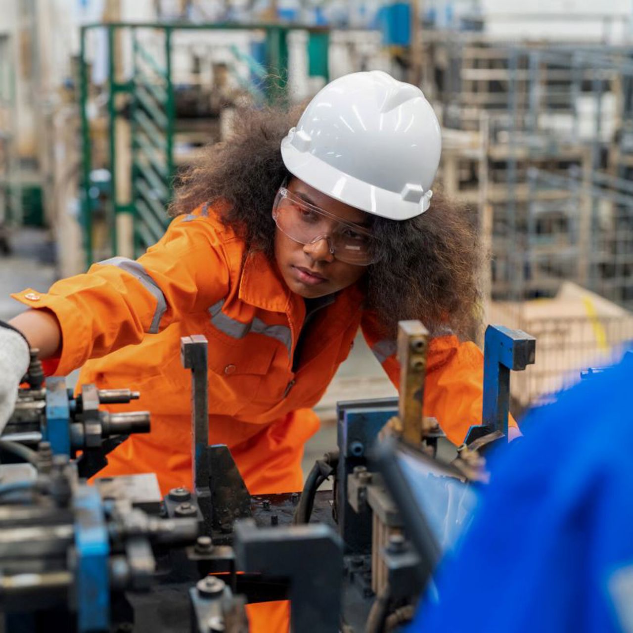 Female electrical engineer checking manufacturing parts