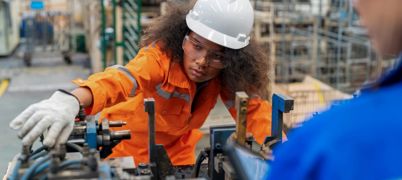 Female electrical engineer checking manufacturing parts