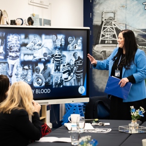 Educator points at screen to adult learners