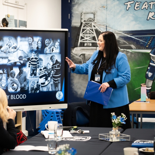 Educator points at screen to adult learners