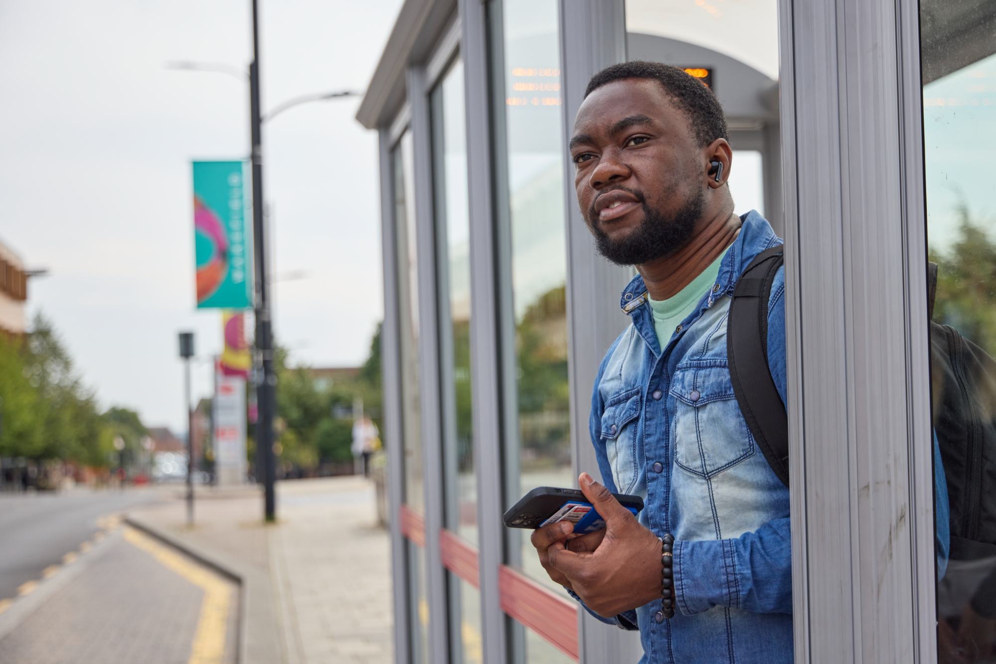 Man Stood At Bus Stop