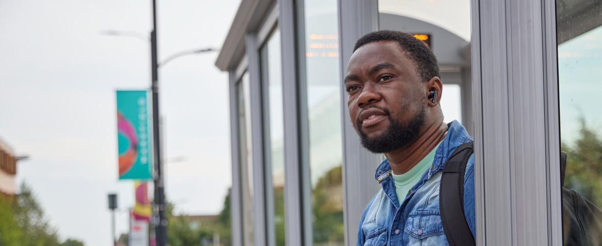Man Stood At Bus Stop
