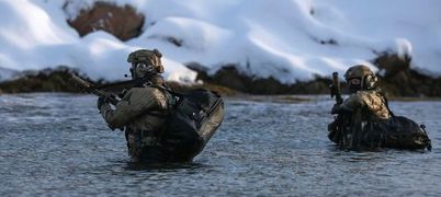 Soldiers walking through water 