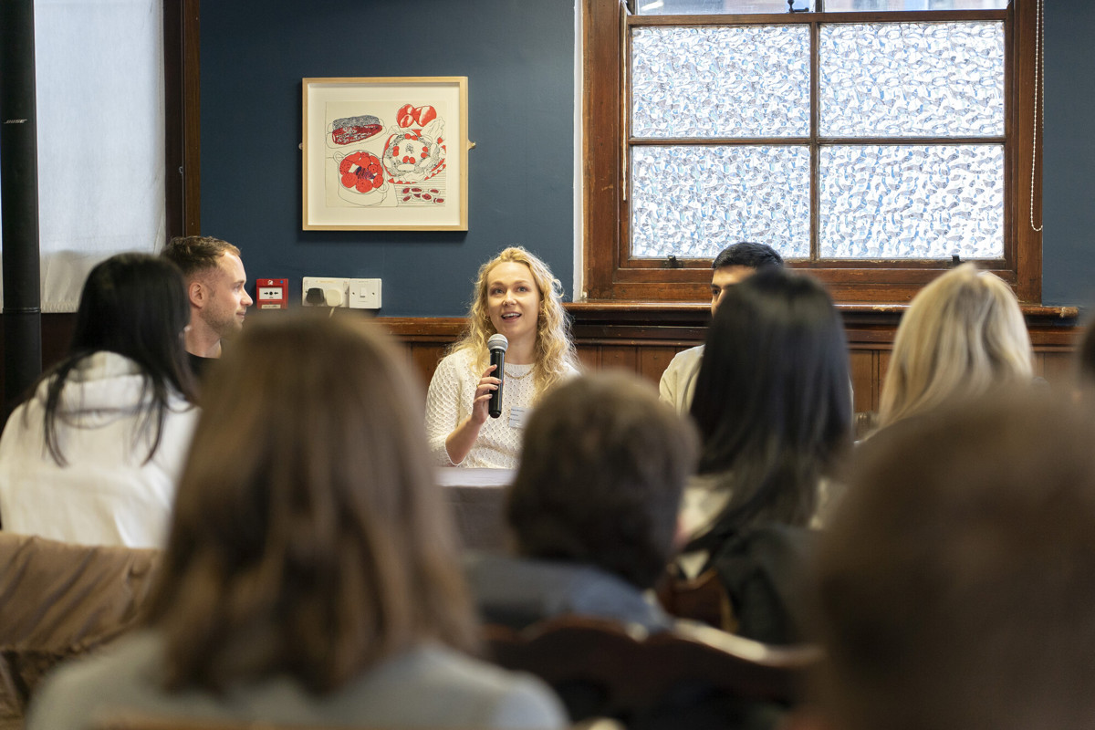 Speaker at graduate event as people listen