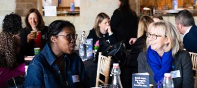 Two Women Talking At The Fair Work Charter Event 2025