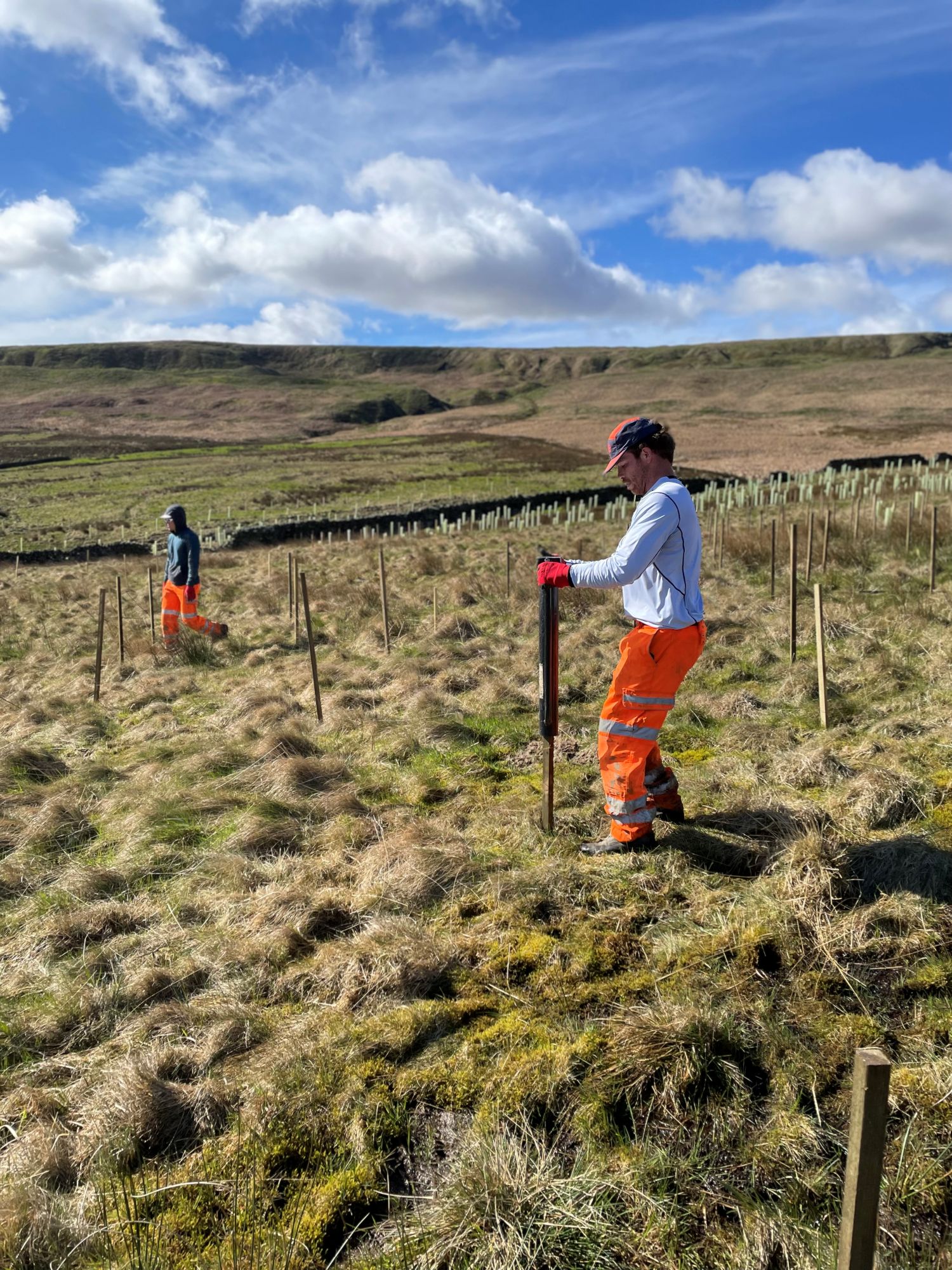 Two people working in a field in Calderdale