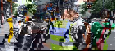 Police officer in uniform at pedestrian crossing 