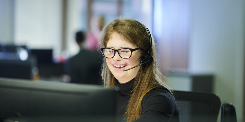 A Young Person Working In An Office Stock
