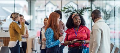 Colleagues chatting in a meeting room following a meeting