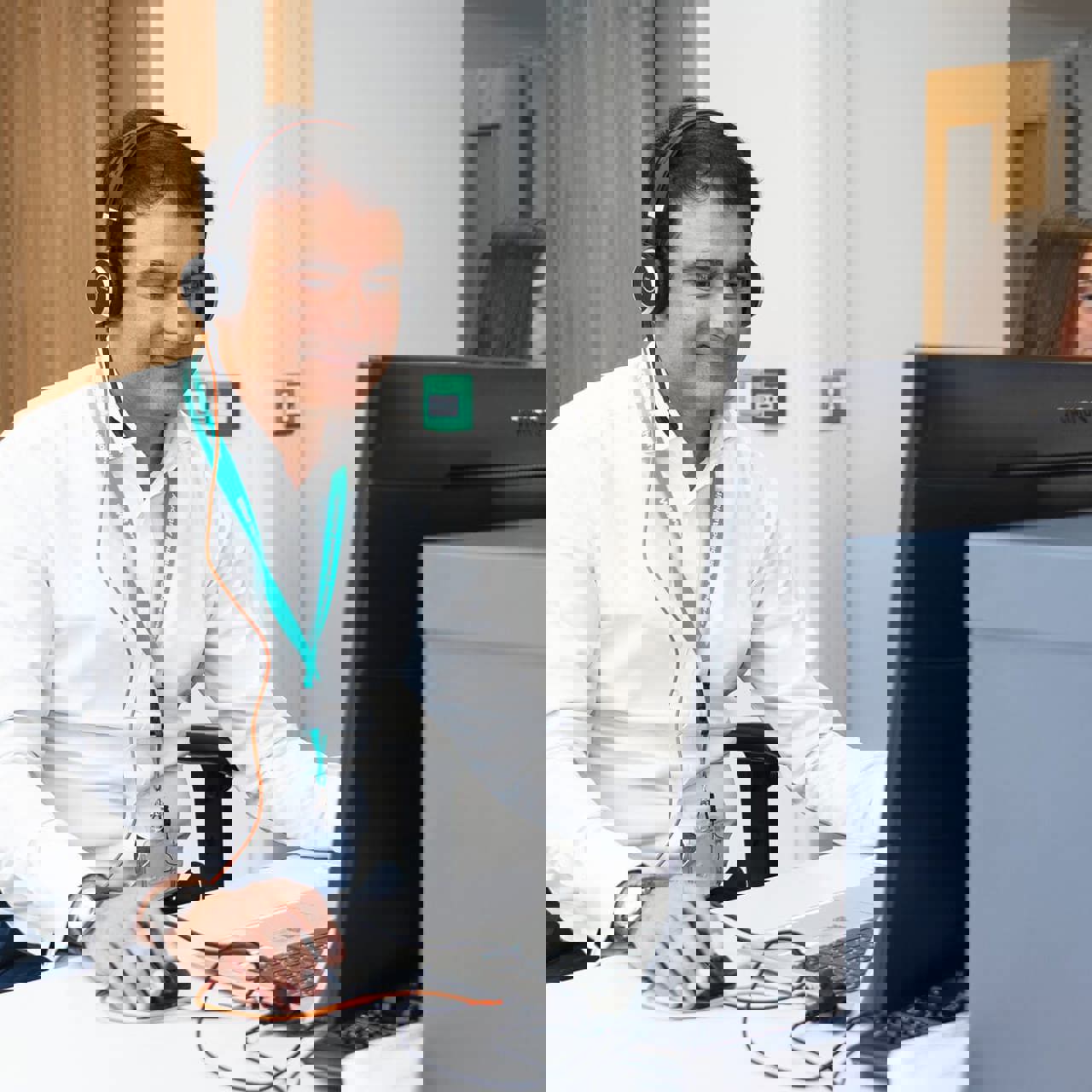 CA Staff Member Sat At Desk With Headset On