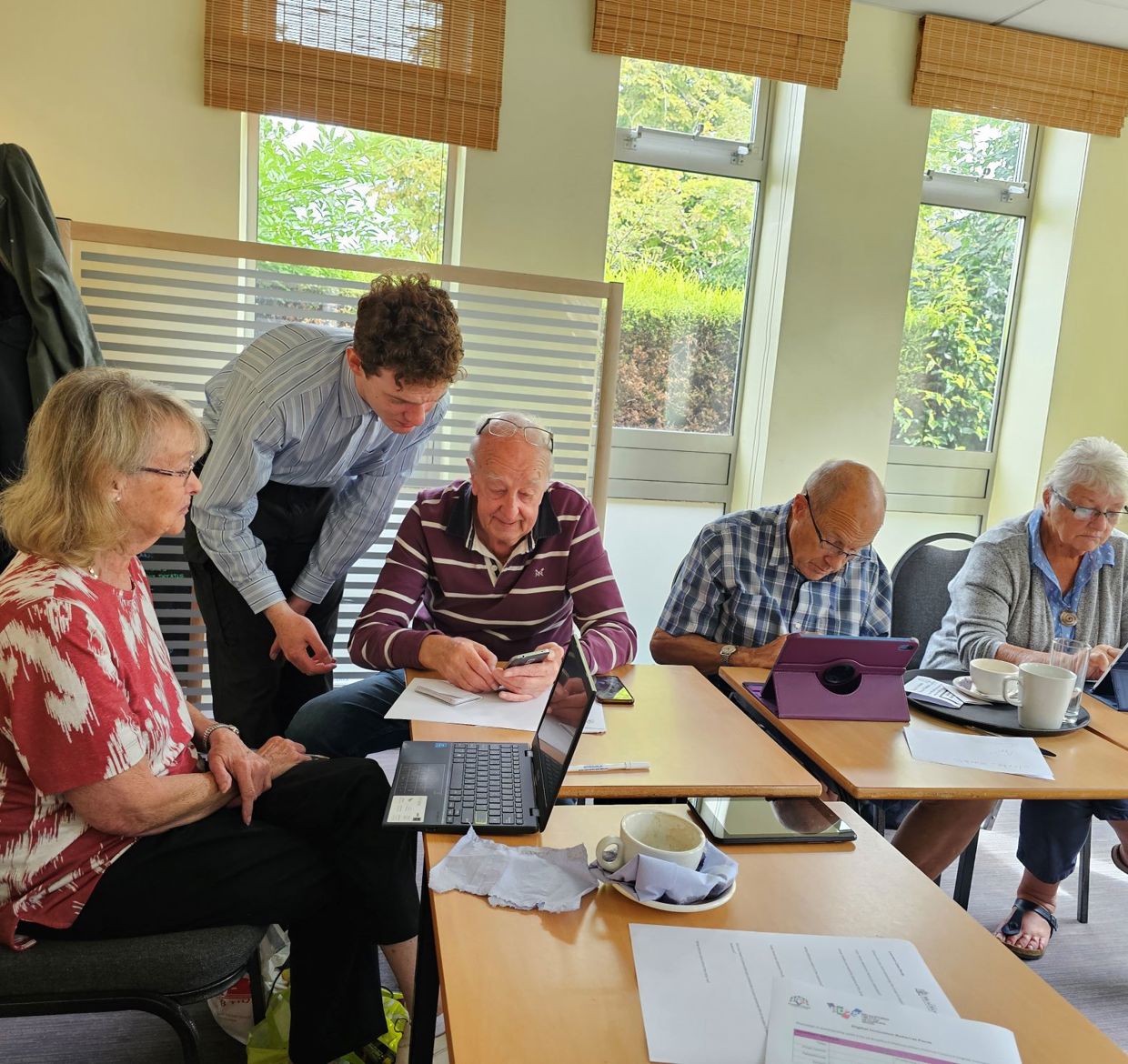 A group of people elderly people using tablets