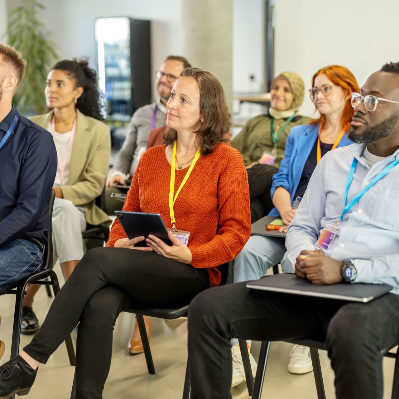 Lines of sitting people look forward, paying attention