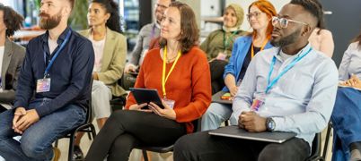 Lines of sitting people look forward, paying attention