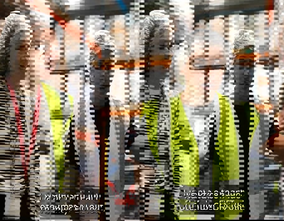 Still from SEND Employer Toolkit Video. Two women in high vis safety wear walk through warehouse