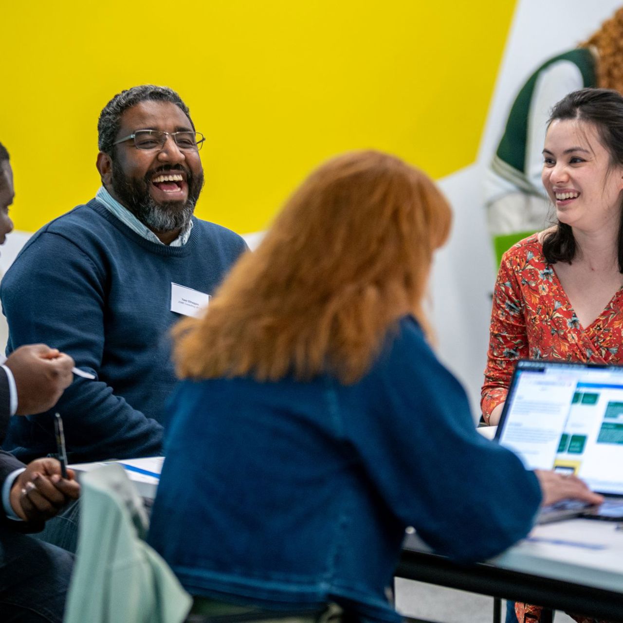 4 people at a table workshopping ideas at the challenge's innovator academy day