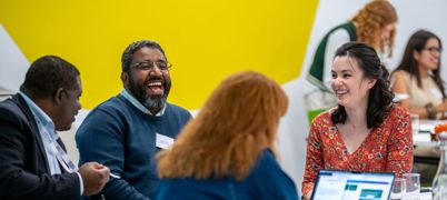 4 people at a table workshopping ideas at the challenge's innovator academy day