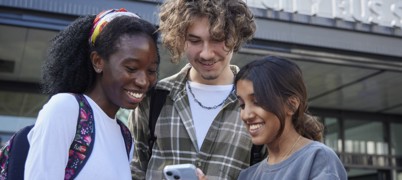 Young people outside bus station with bus-only MCard tickets