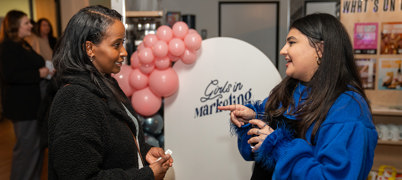 Two women speaking at an event