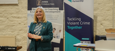 Mayor Tracy Brabin standing in front of two pop-up banners speaking to an audience