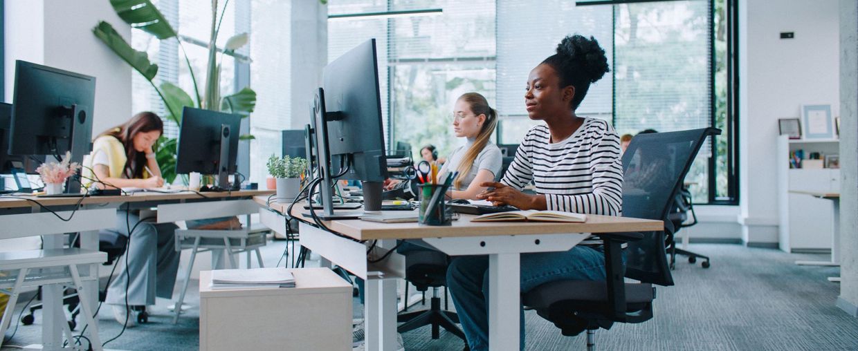 People Working At Computers In An Office