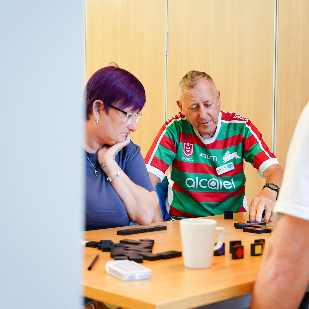 Three people sat at a table engaged in an activity