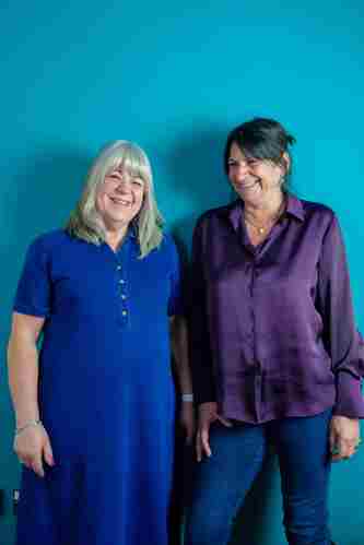 Two women stood next to each other smiling