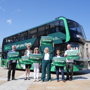 West Yorkshire leaders standing in front of a bus with the new, green Weaver design