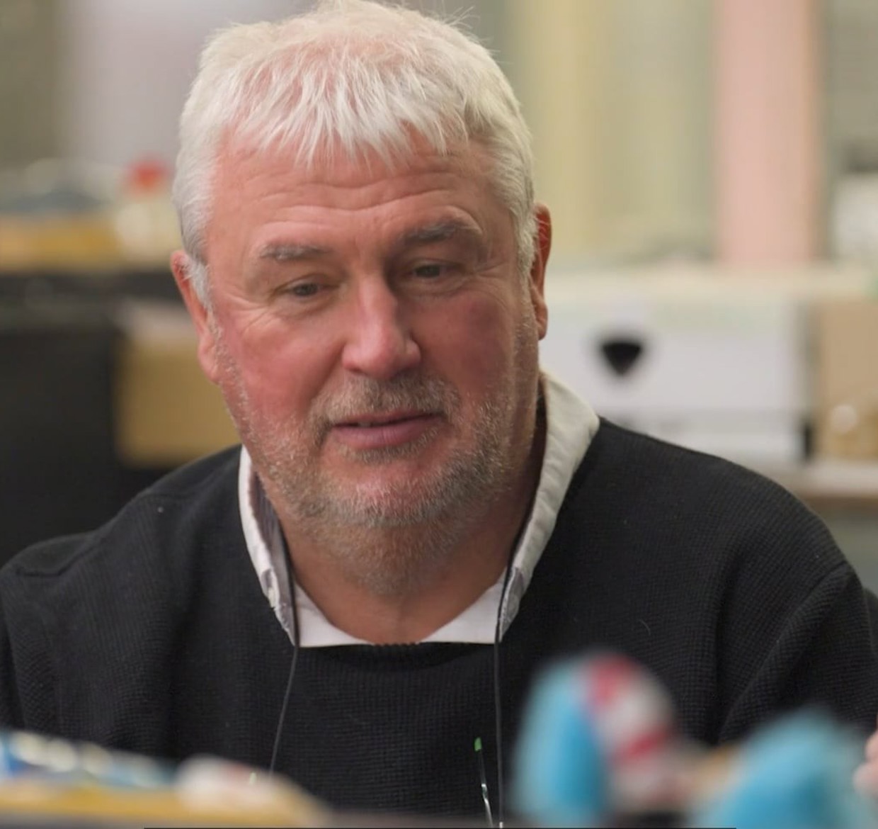 Two men sat down, having a conversation