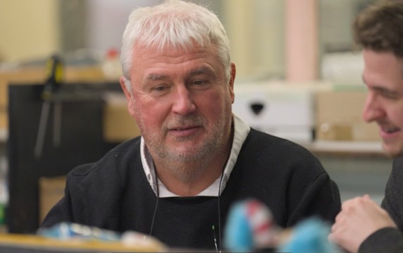 Two men sat down, having a conversation